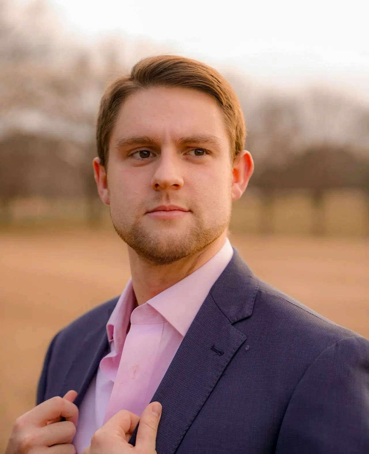 man wearing inner dress shirt with black blazer standing outside at daytime